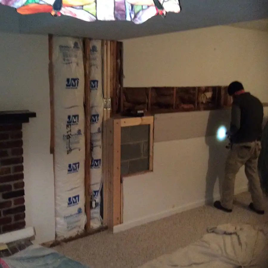Restoration technician inspecting water damage in Kahului